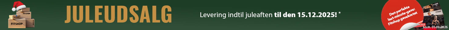Et jule-reklamebanner med grøn baggrund og en lyskæde langs toppen. Til venstre ligger flere gaver med teksten “Fitshop”, og ved siden af dem ses flere Fitshop-gavekort. I et rødt fremhævet felt står der: “Den perfekte last-minute-gave: Fitshop-gavekortet.” Til højre står der med store bogstaver “Juleudsalg” samt teksten “Levering indtil juleaften ved bestilling til den 15.12.2025!*”.